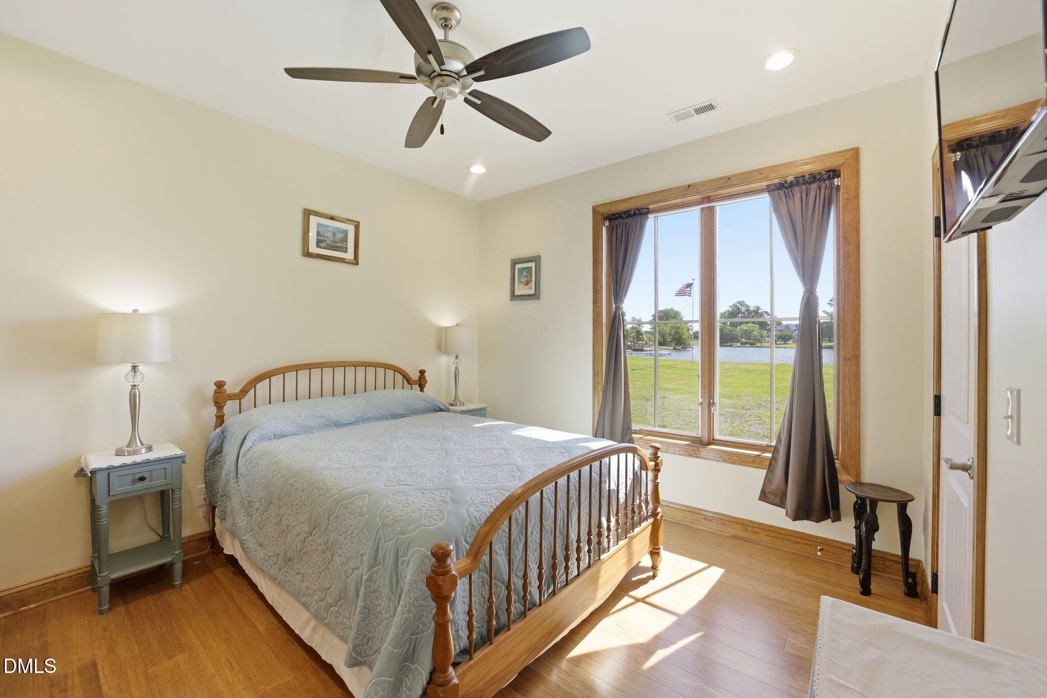 35 North Rippling Court Smithfield, NC 27577 - Photo 36 of 59 a bedroom with a large bed and a chandelier