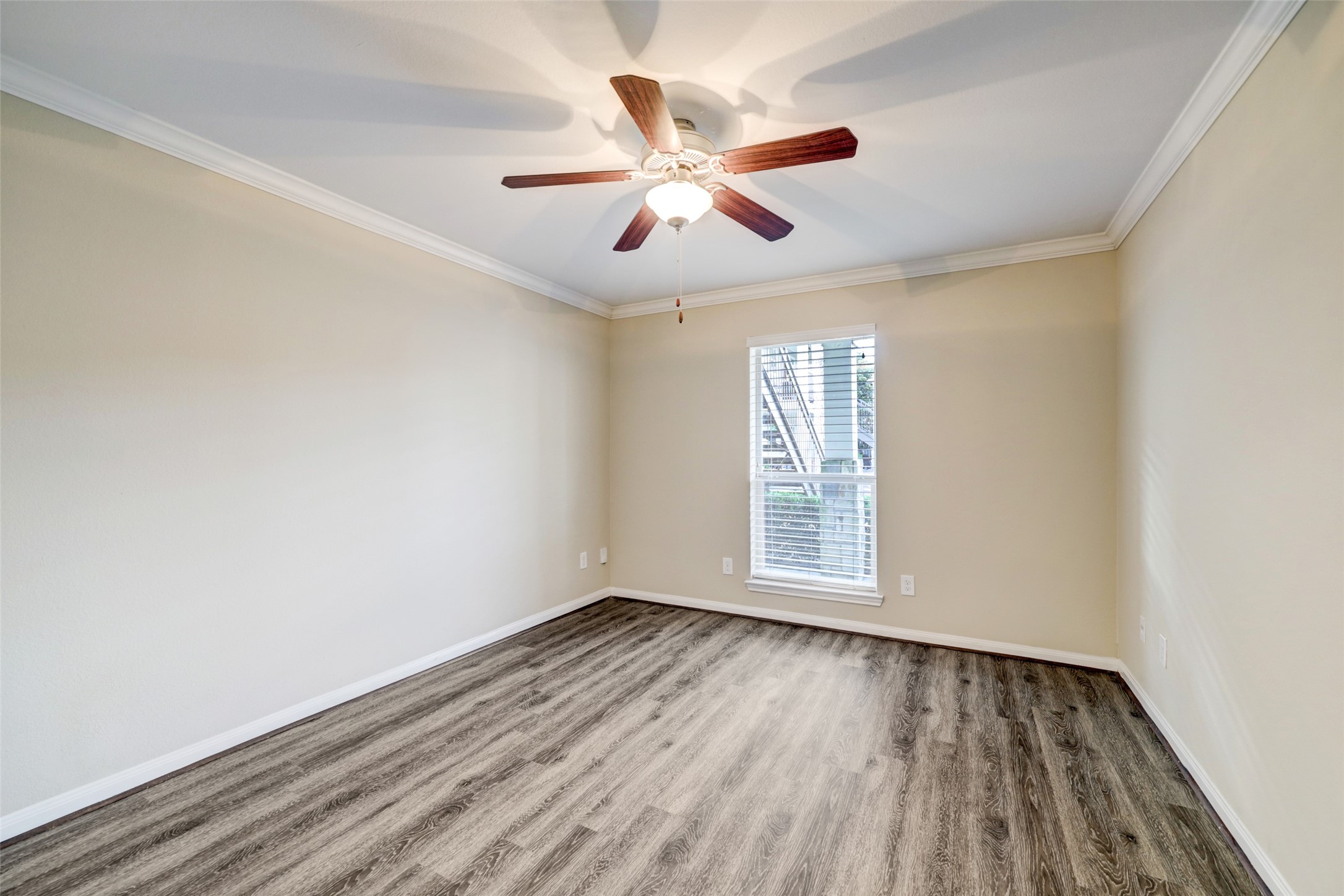 1600 West T C Jester Boulevard, Unit 14 Houston, TX 77008 - Photo 6 of 11 wooden floor in an empty room with a window