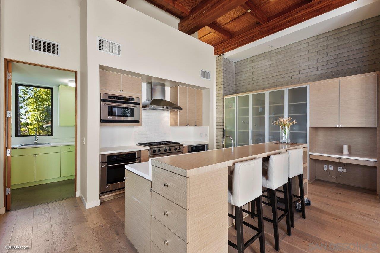 3545 Dove Hollow Road Encinitas, CA 92024 - Photo 16 of 69 a kitchen with a stove a sink and a refrigerator