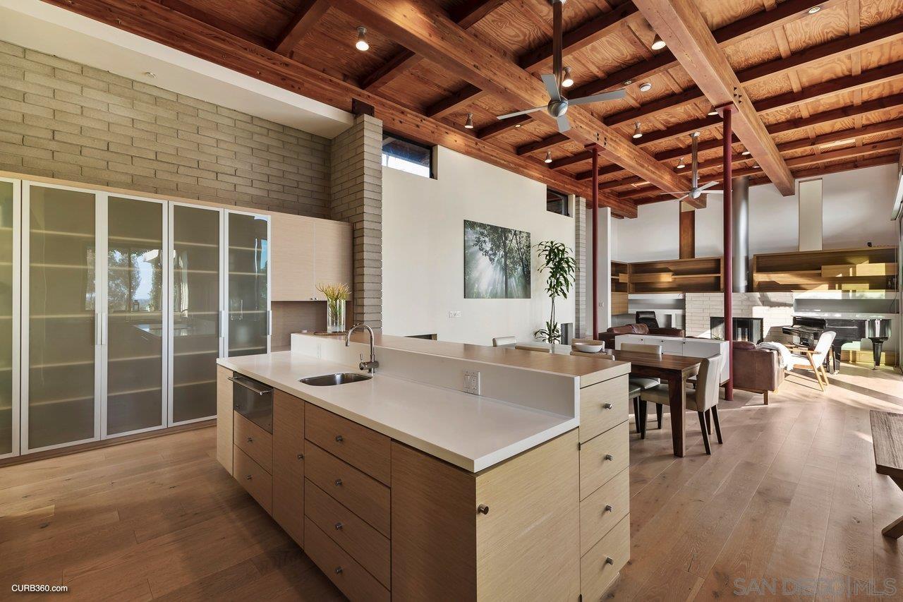 3545 Dove Hollow Road Encinitas, CA 92024 - Photo 17 of 69 a kitchen with a sink stove and wooden cabinets