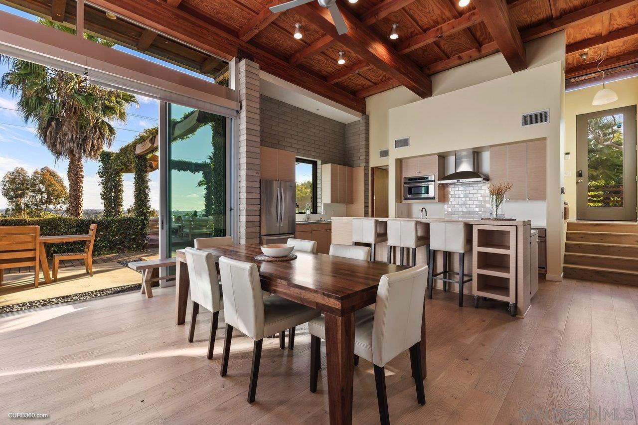 3545 Dove Hollow Road Encinitas, CA 92024 - Photo 19 of 69 a dining room with furniture window and wooden floor