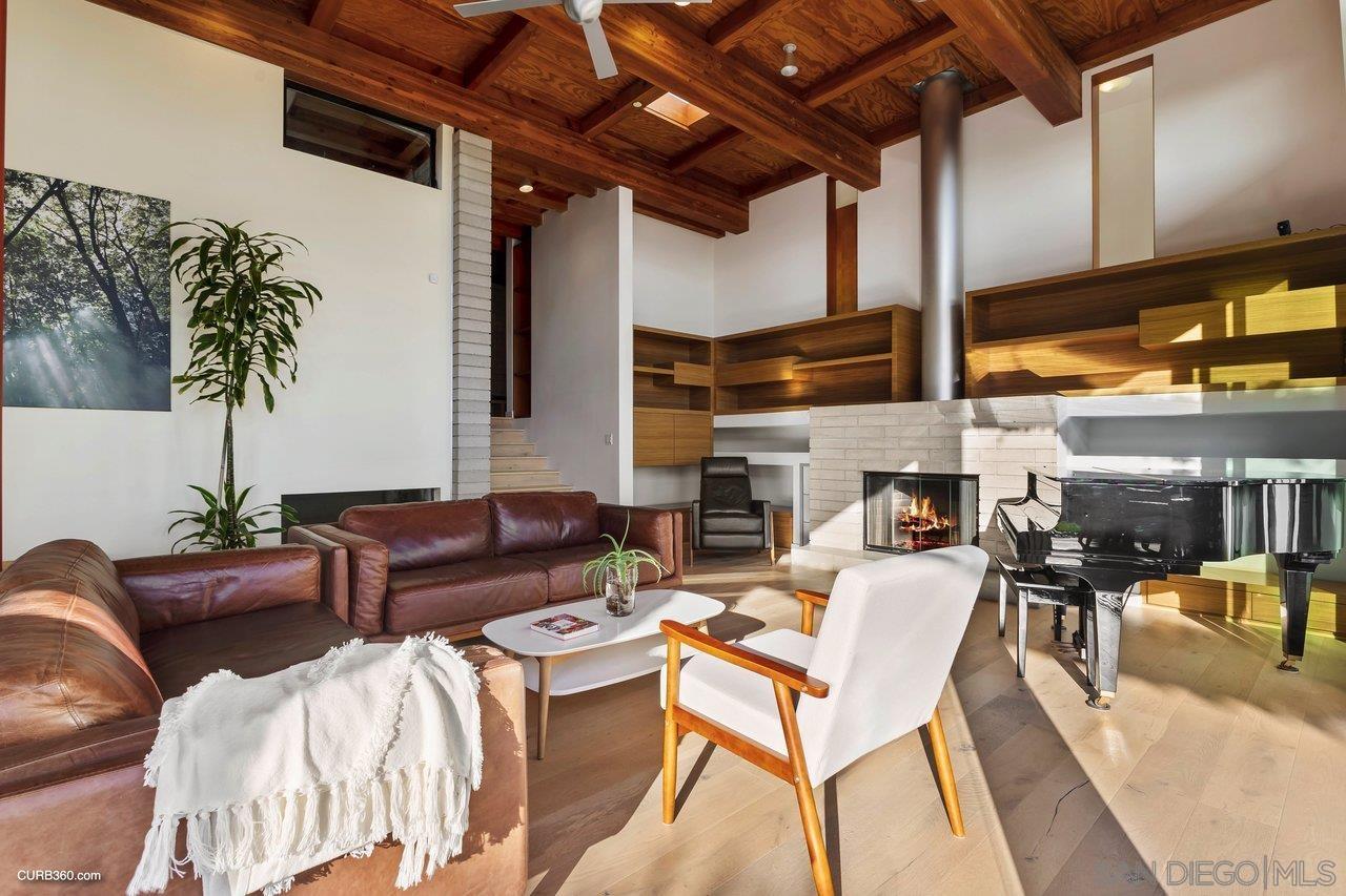 3545 Dove Hollow Road Encinitas, CA 92024 - Photo 21 of 69 a living room with furniture a fireplace and a potted plant