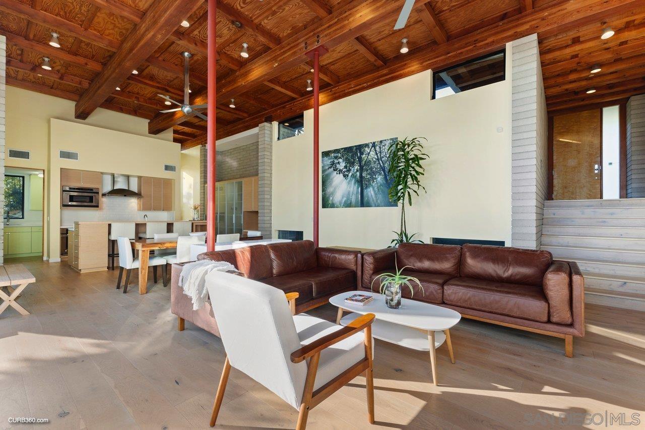 3545 Dove Hollow Road Encinitas, CA 92024 - Photo 24 of 69 a living room with furniture and a chandelier