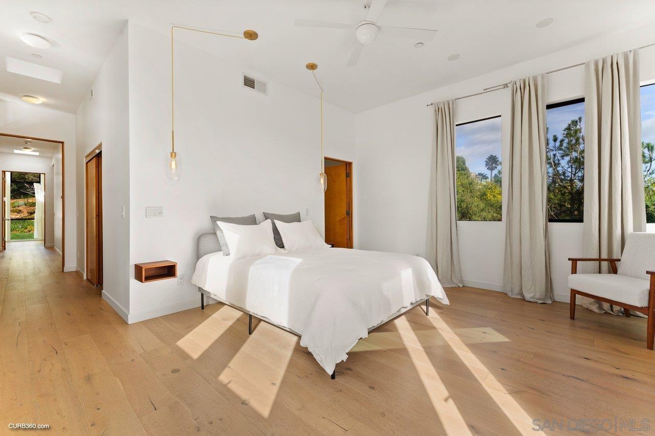 3545 Dove Hollow Road Encinitas, CA 92024 - Photo 27 of 69 a bedroom with a bed lamp closet and large window