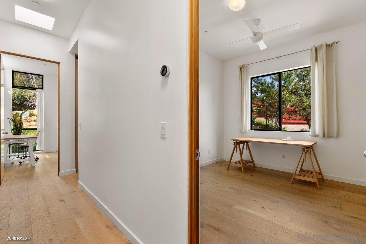 3545 Dove Hollow Road Encinitas, CA 92024 - Photo 37 of 69 a view of an empty room with a window and wooden floor