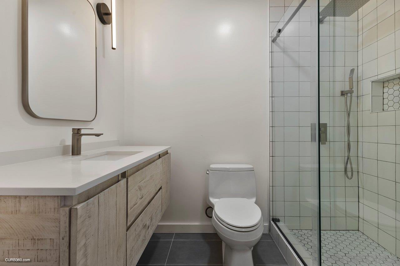 3545 Dove Hollow Road Encinitas, CA 92024 - Photo 42 of 69 a bathroom with a toilet sink and mirror