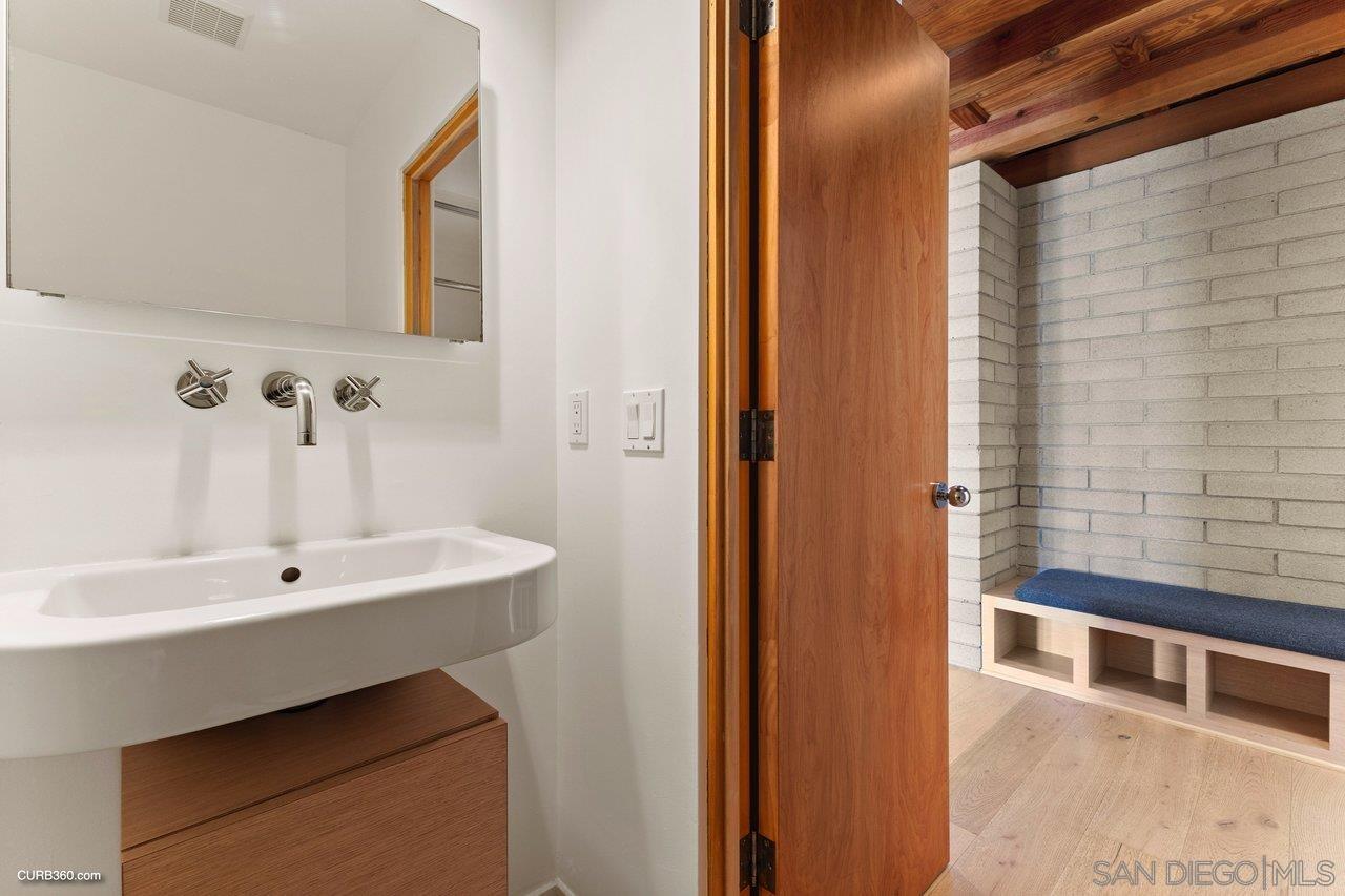 3545 Dove Hollow Road Encinitas, CA 92024 - Photo 43 of 69 a bathroom with a sink and a mirror