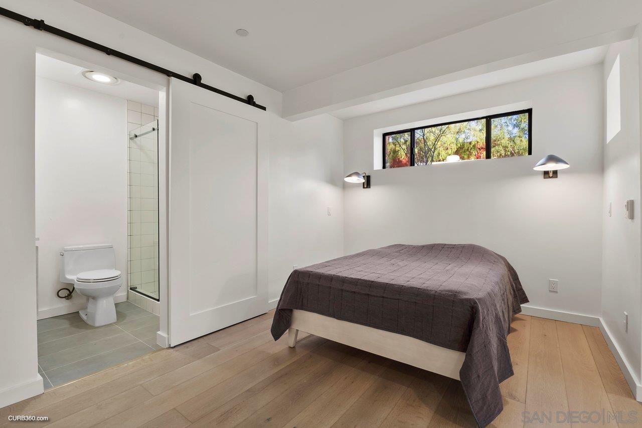 3545 Dove Hollow Road Encinitas, CA 92024 - Photo 44 of 69 a bedroom with a bed and a window