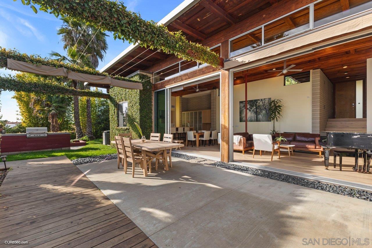 3545 Dove Hollow Road Encinitas, CA 92024 - Photo 50 of 69 a view of a patio with table and chairs and floor to ceiling window