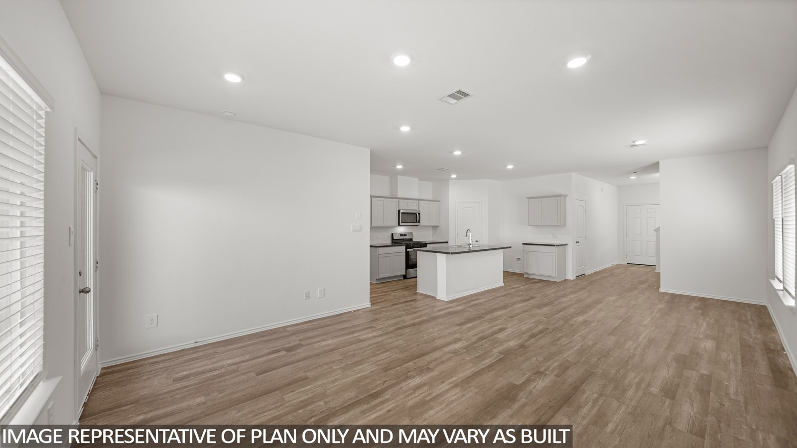 125 Rising Cedar Lane Hockley, TX 77447 - Photo 7 of 19 a view of kitchen with kitchen island microwave and wooden floor