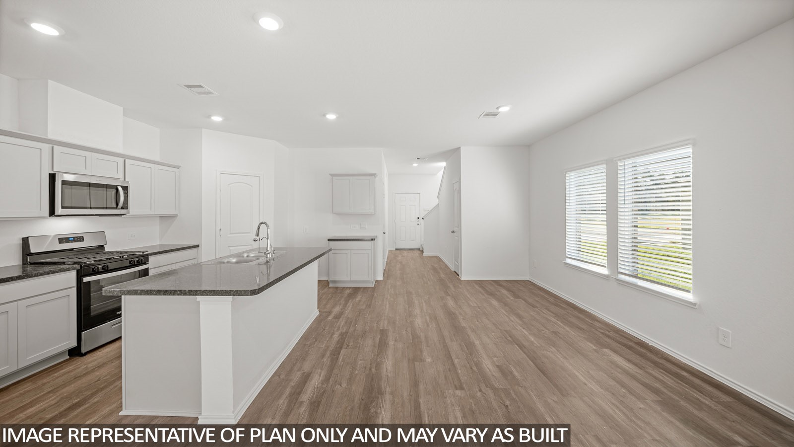 125 Rising Cedar Lane Hockley, TX 77447 - Photo 8 of 19 a view of a kitchen with a sink wooden floor and windows
