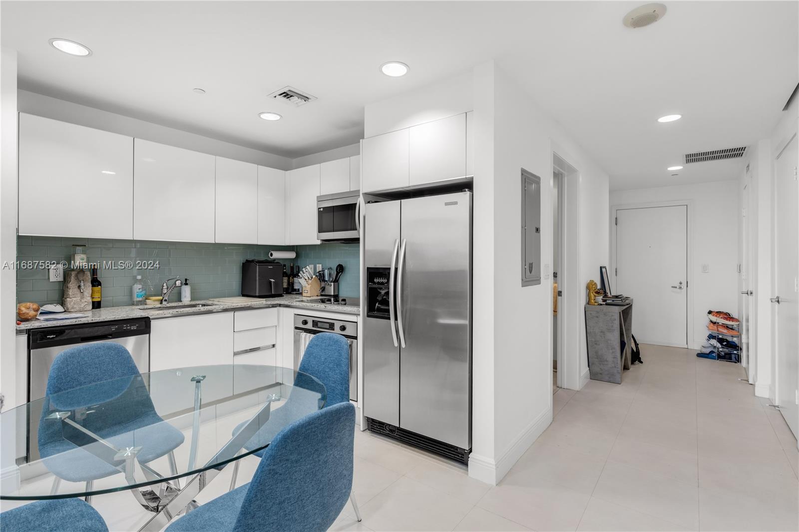 1060 Brickell Avenue, Unit 409 Miami, FL 33131 - Photo 7 of 25 a kitchen with a refrigerator a oven and white cabinets