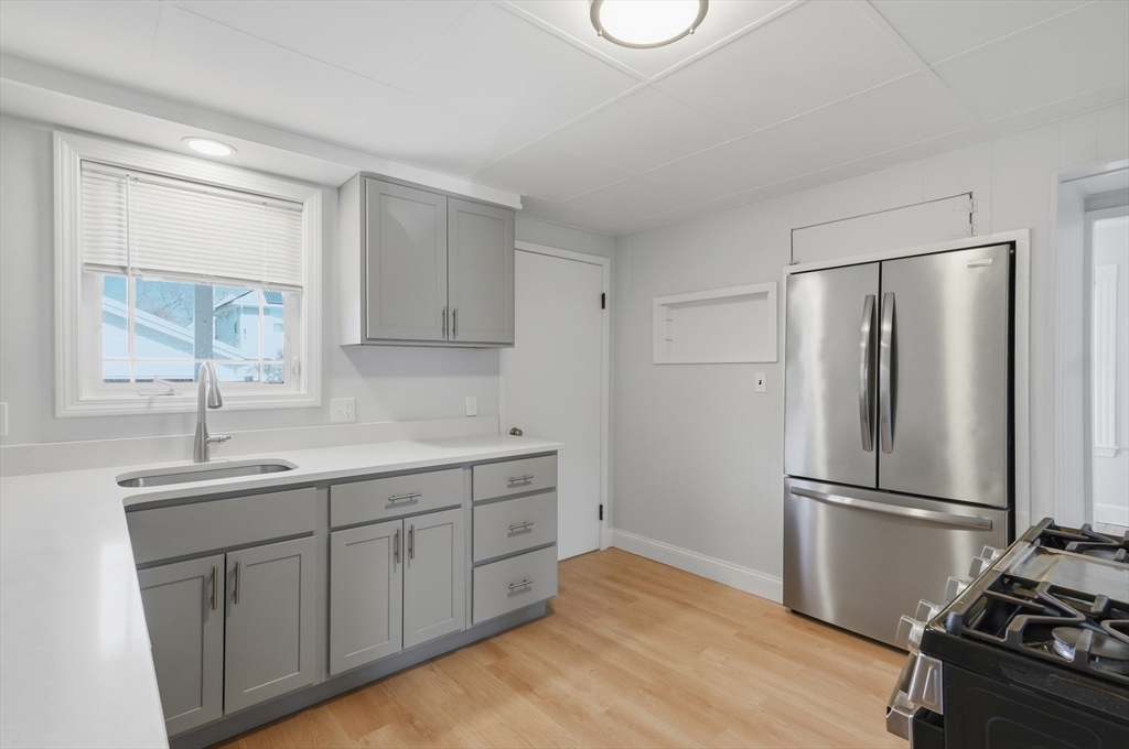 55 Addison Avenue Lynn, MA 01902 - Photo 4 of 23 a kitchen with a refrigerator sink and cabinets