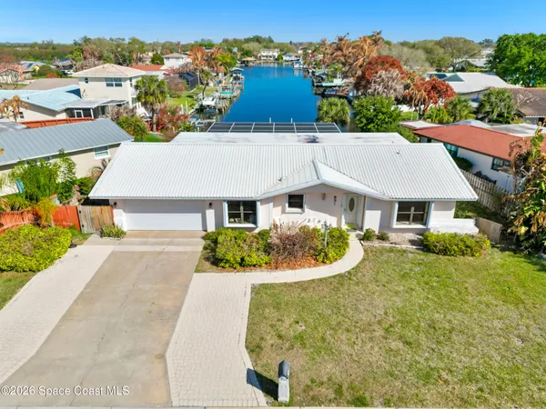 an aerial view of a house with a yard
