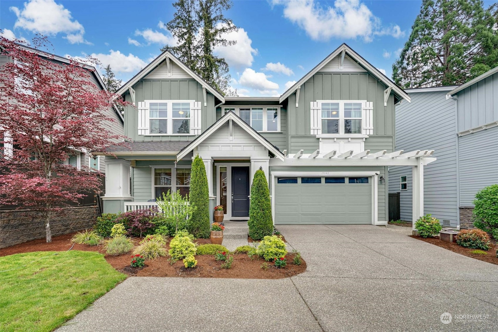 19042 84th Place Northeast Bothell, WA 98011 - Photo 3 of 40 a front view of a house with a garden