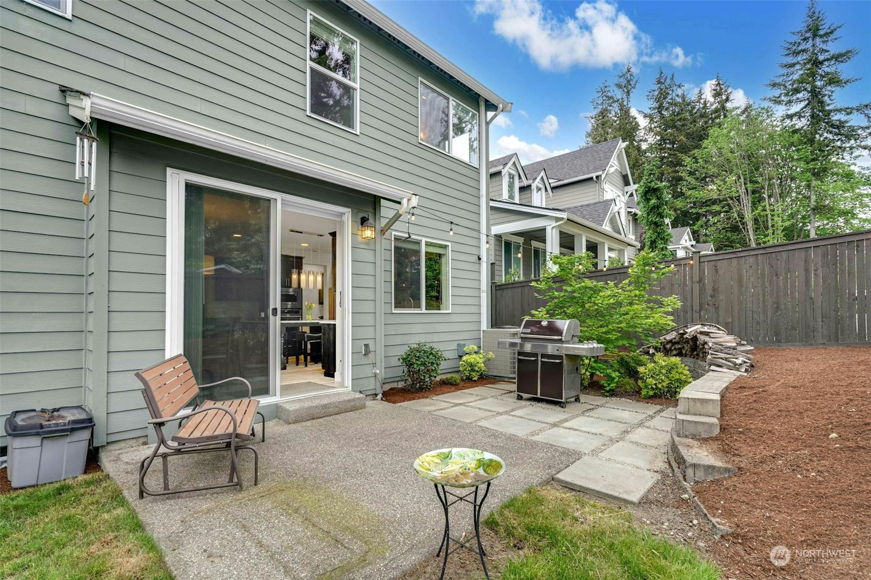 19042 84th Place Northeast Bothell, WA 98011 - Photo 35 of 40 a view of a patio with table and chairs potted plants and wooden fence