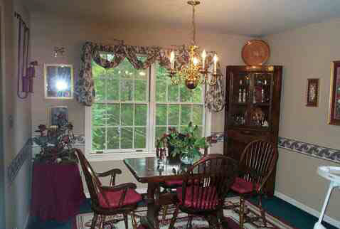 1018 Durrett Ridge Road Earlysville, VA 22936 - Photo 2 of 4 a view of a dining room with furniture a chandelier and window