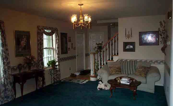 1018 Durrett Ridge Road Earlysville, VA 22936 - Photo 4 of 4 a living room with furniture and a chandelier
