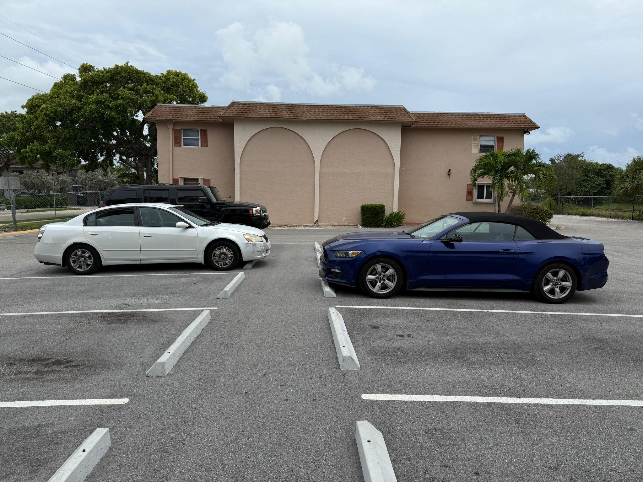 650 Southwest 2nd Avenue, Unit 2490 Boca Raton, FL 33432 - Photo 1 of 18 a front view of a house with parking space