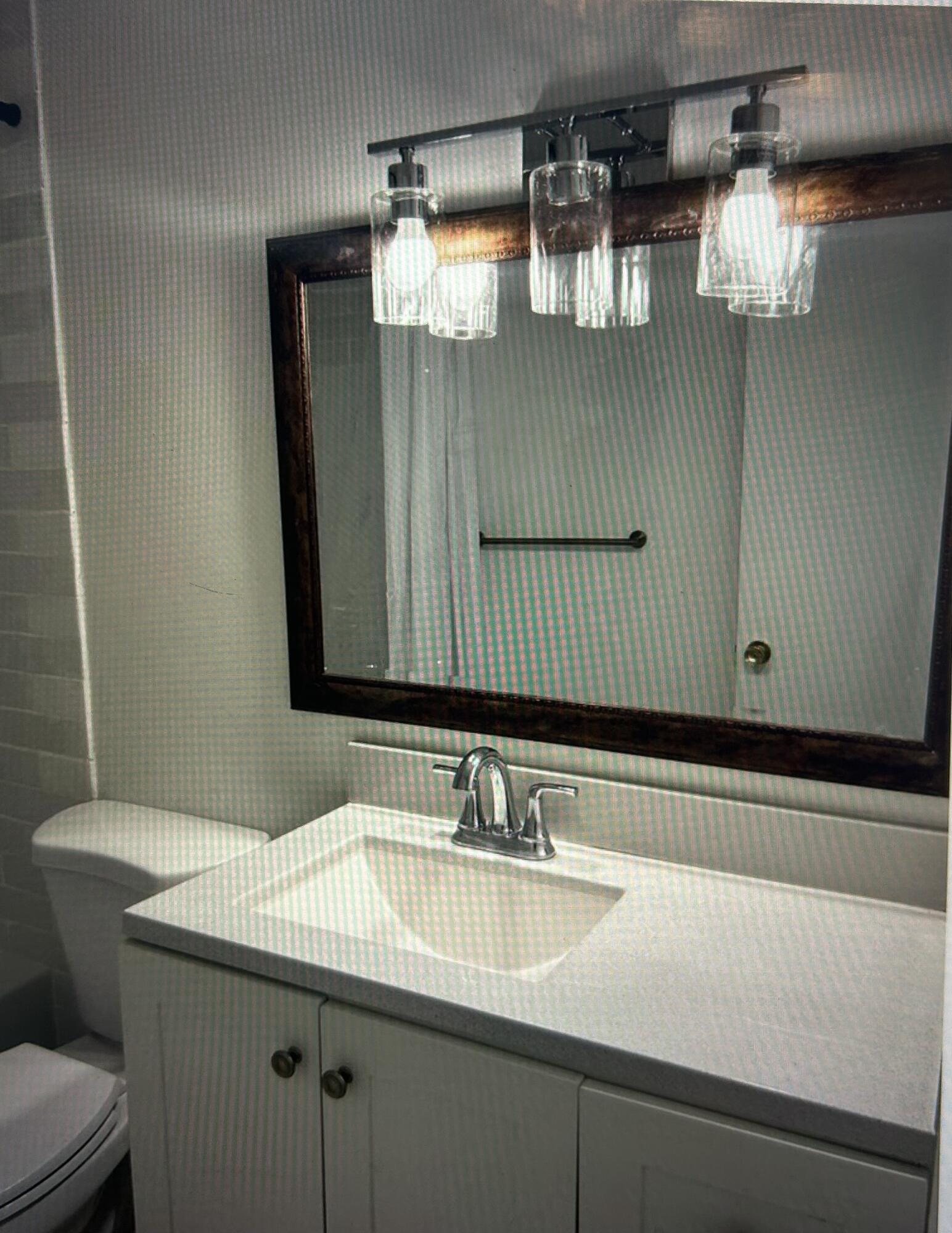 650 Southwest 2nd Avenue, Unit 2490 Boca Raton, FL 33432 - Photo 13 of 18 a bathroom with a sink and a mirror