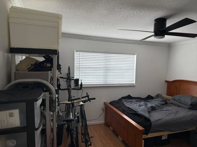 a bed sitting in a bedroom next to a window