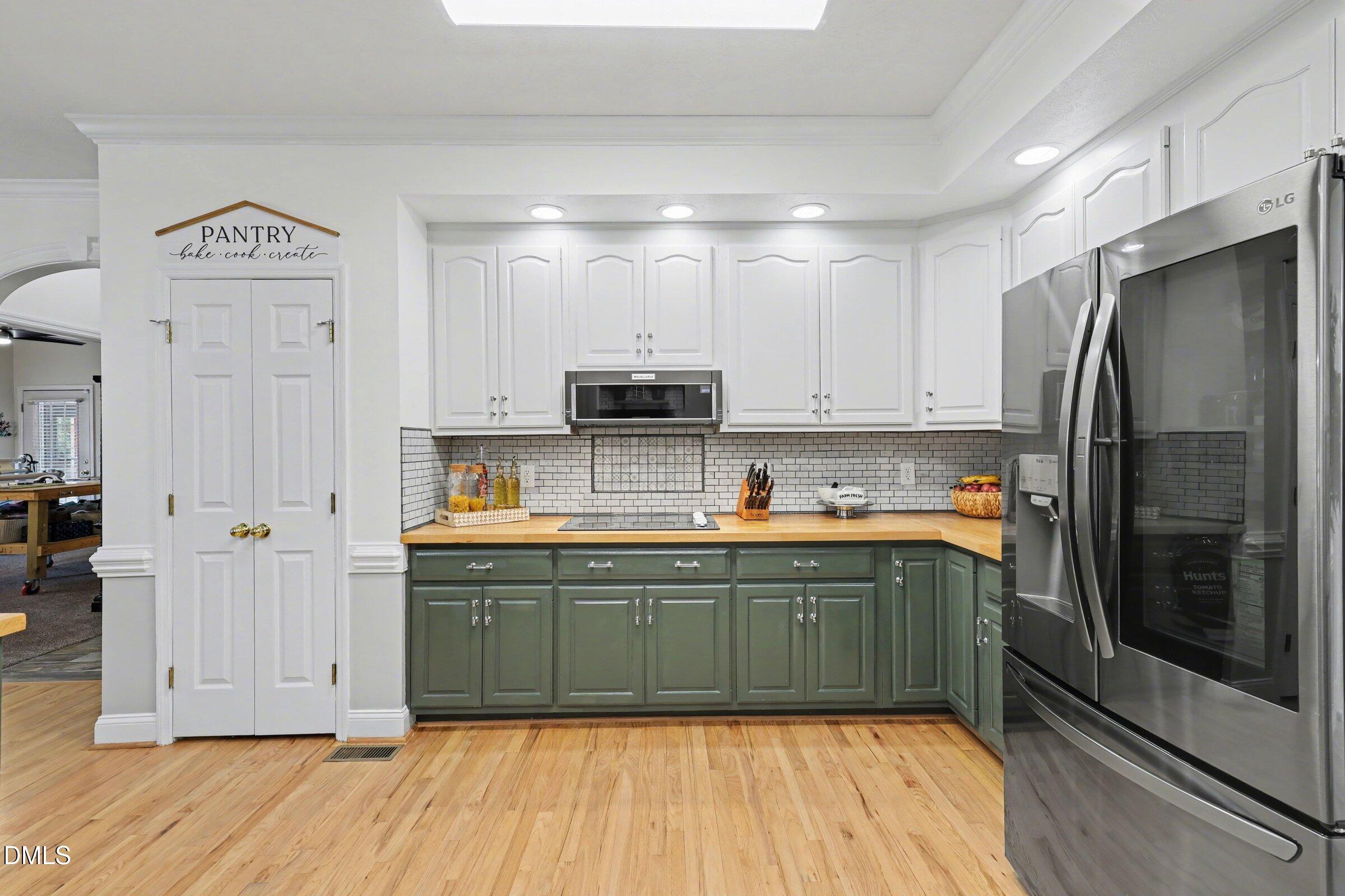 430 Fred Hall Road Stedman, NC 28391 - Photo 14 of 63 a kitchen with stainless steel appliances granite countertop a refrigerator and a sink