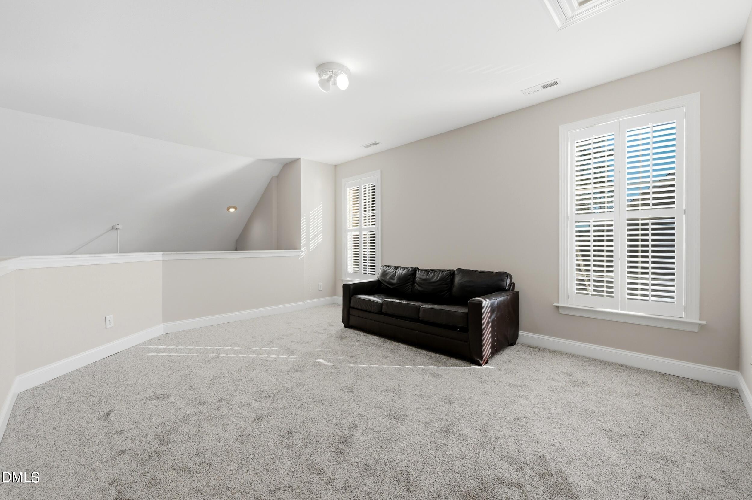 4803 Marena Place Durham, NC 27707 - Photo 20 of 42 a living room with furniture and a flat screen tv