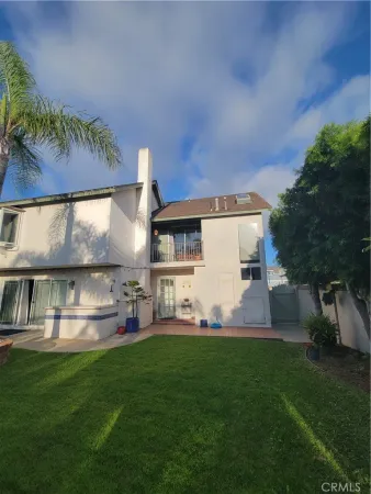 a view of a back yard of the house with green space