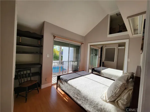 a bedroom with a bed a dresser and book shelf