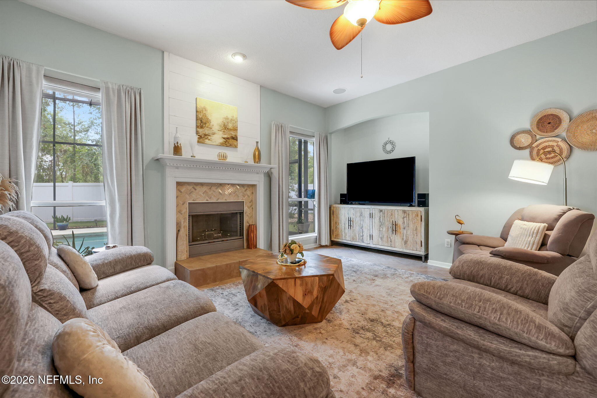 4320 Rye Court St. Johns, FL 32259 - Photo 14 of 60 a living room with furniture a flat screen tv and a fireplace