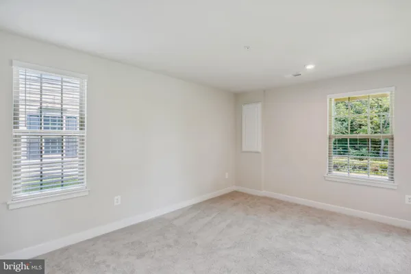 a view of a room with gym equipment and a ceiling fan