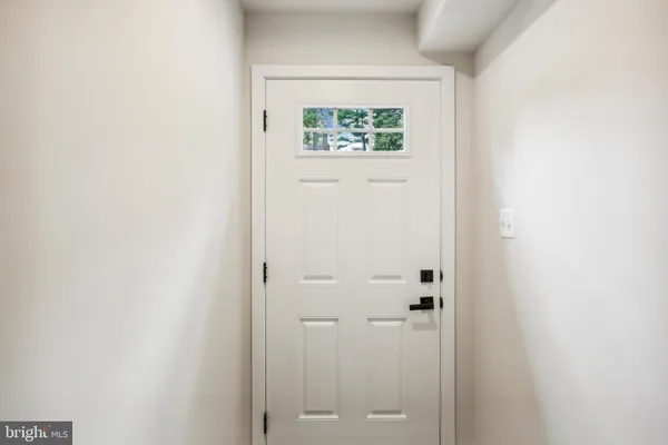 a view of hallway with closet and a window