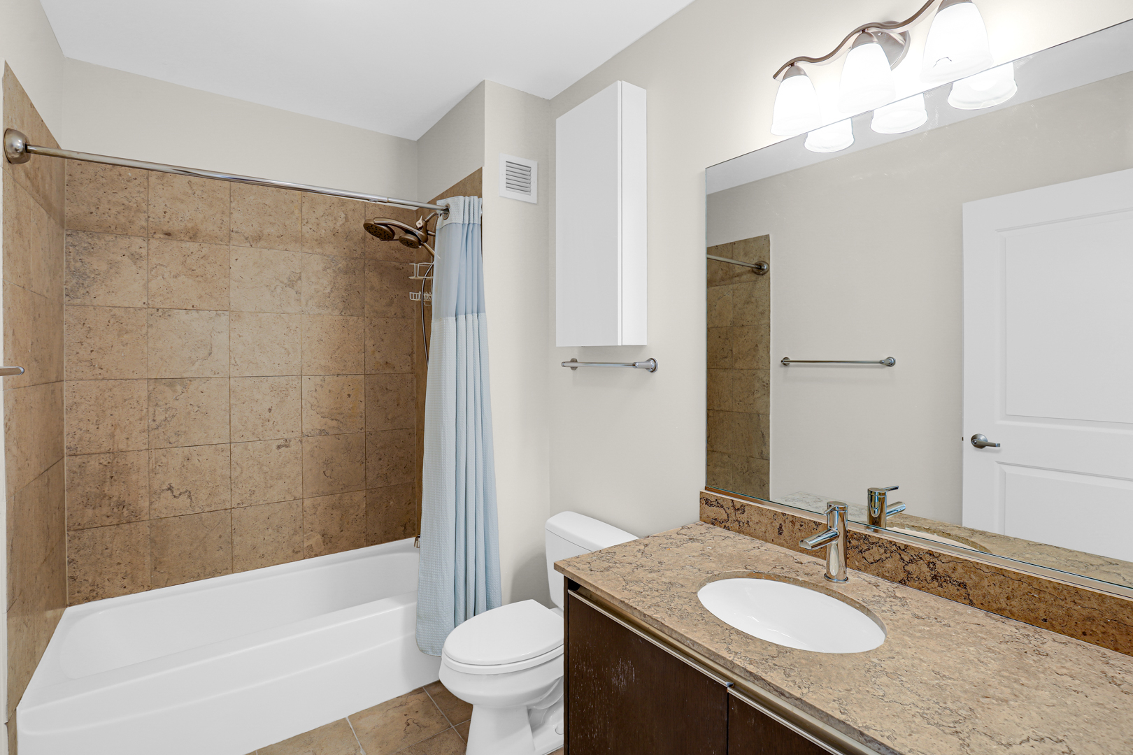 225 North Columbus Drive, Unit 5311 Chicago, IL 60601 - Photo 14 of 36 a bathroom with a granite countertop sink toilet mirror and shower