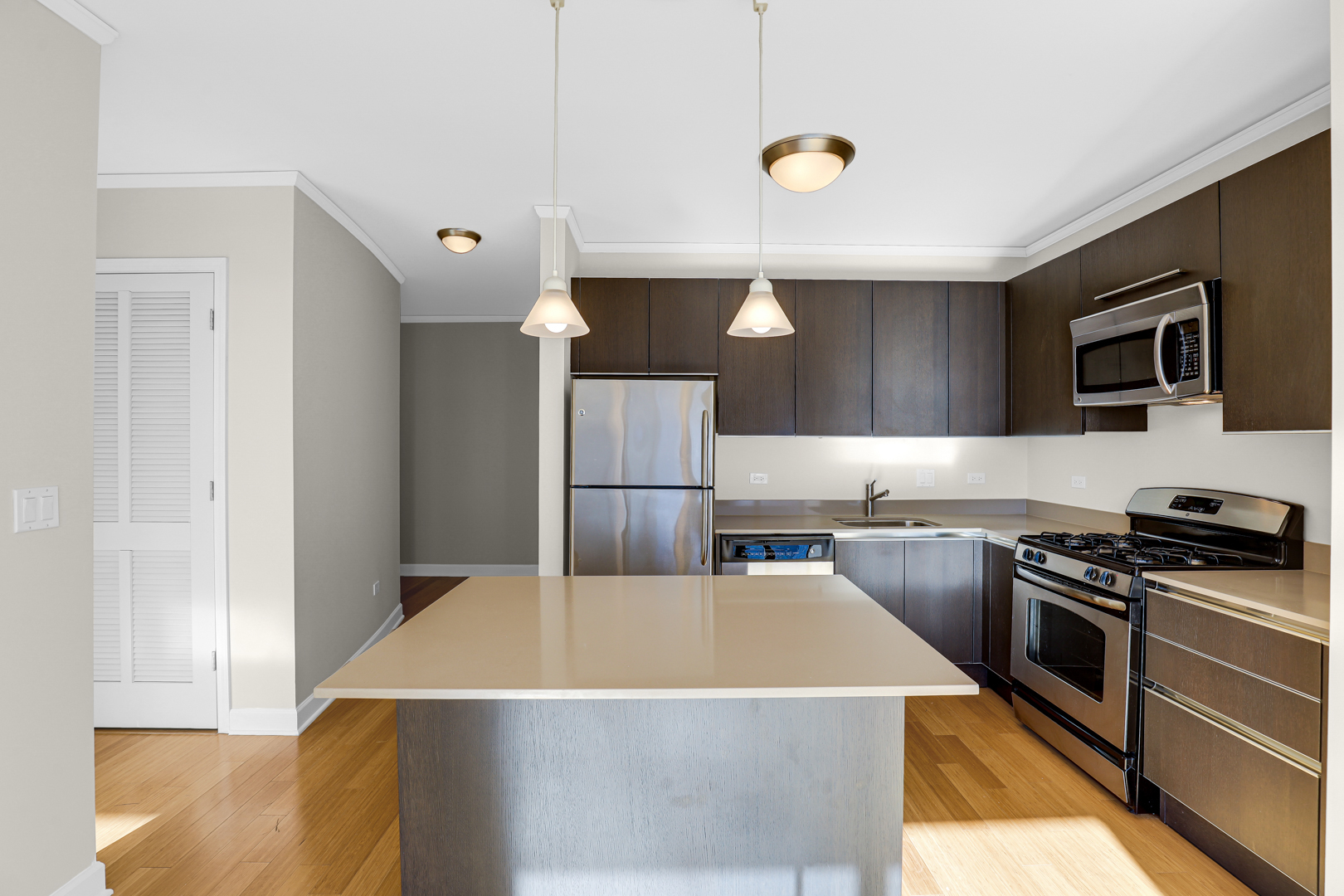 225 North Columbus Drive, Unit 5311 Chicago, IL 60601 - Photo 8 of 36 a kitchen with a stove a sink and a refrigerator