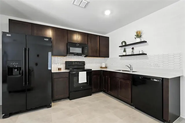 a kitchen with a refrigerator and a sink