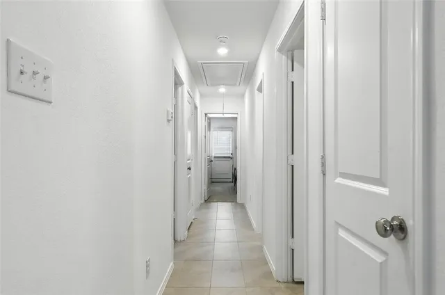 a view of a hallway with wooden shelves