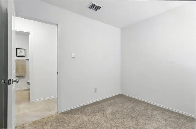 an empty room with closet area