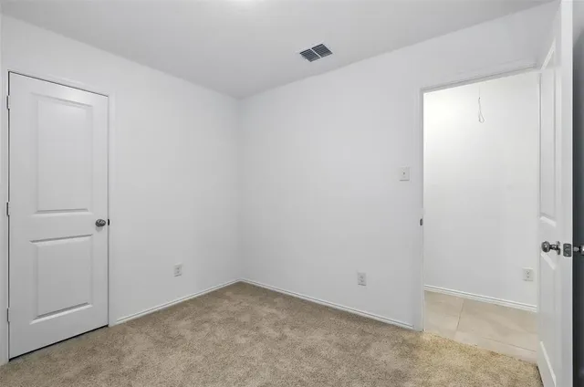 a view of an empty room and a window