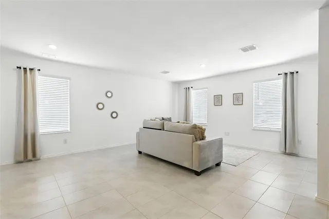 a living room with furniture and kitchen view