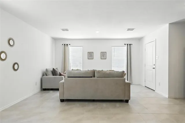 a view of a room with window and a chandelier