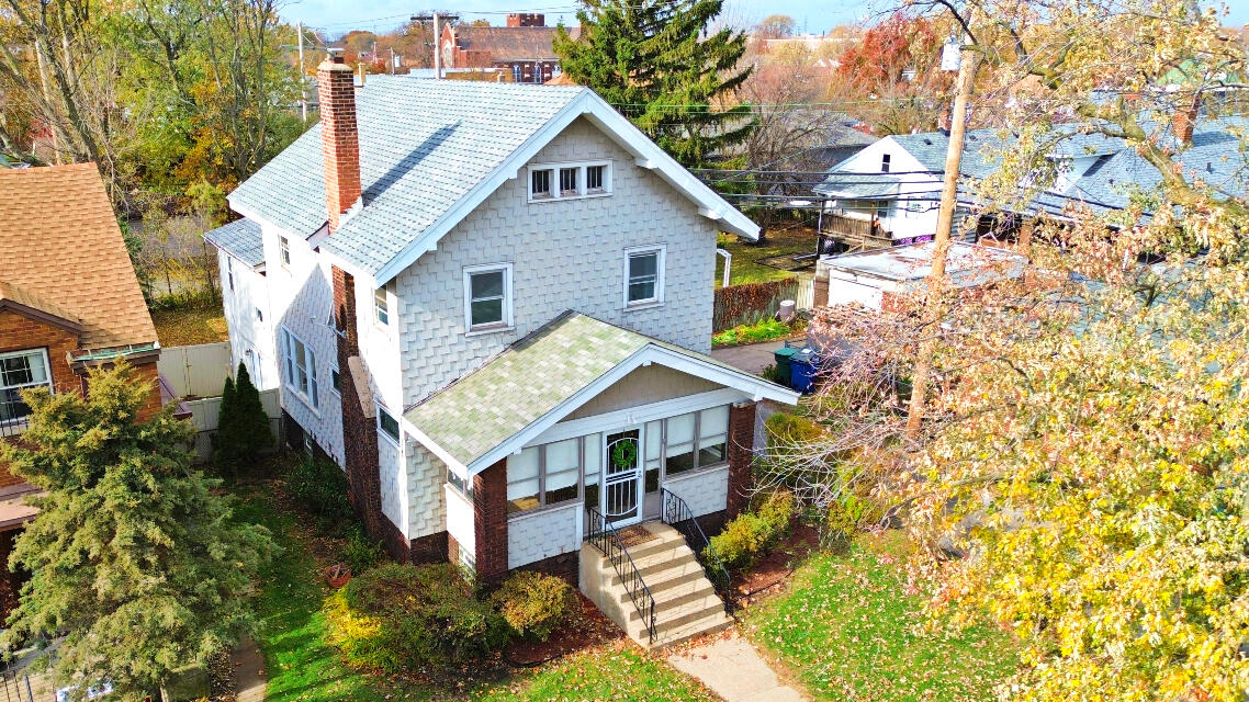 a aerial view of a house with a yard and potted plants