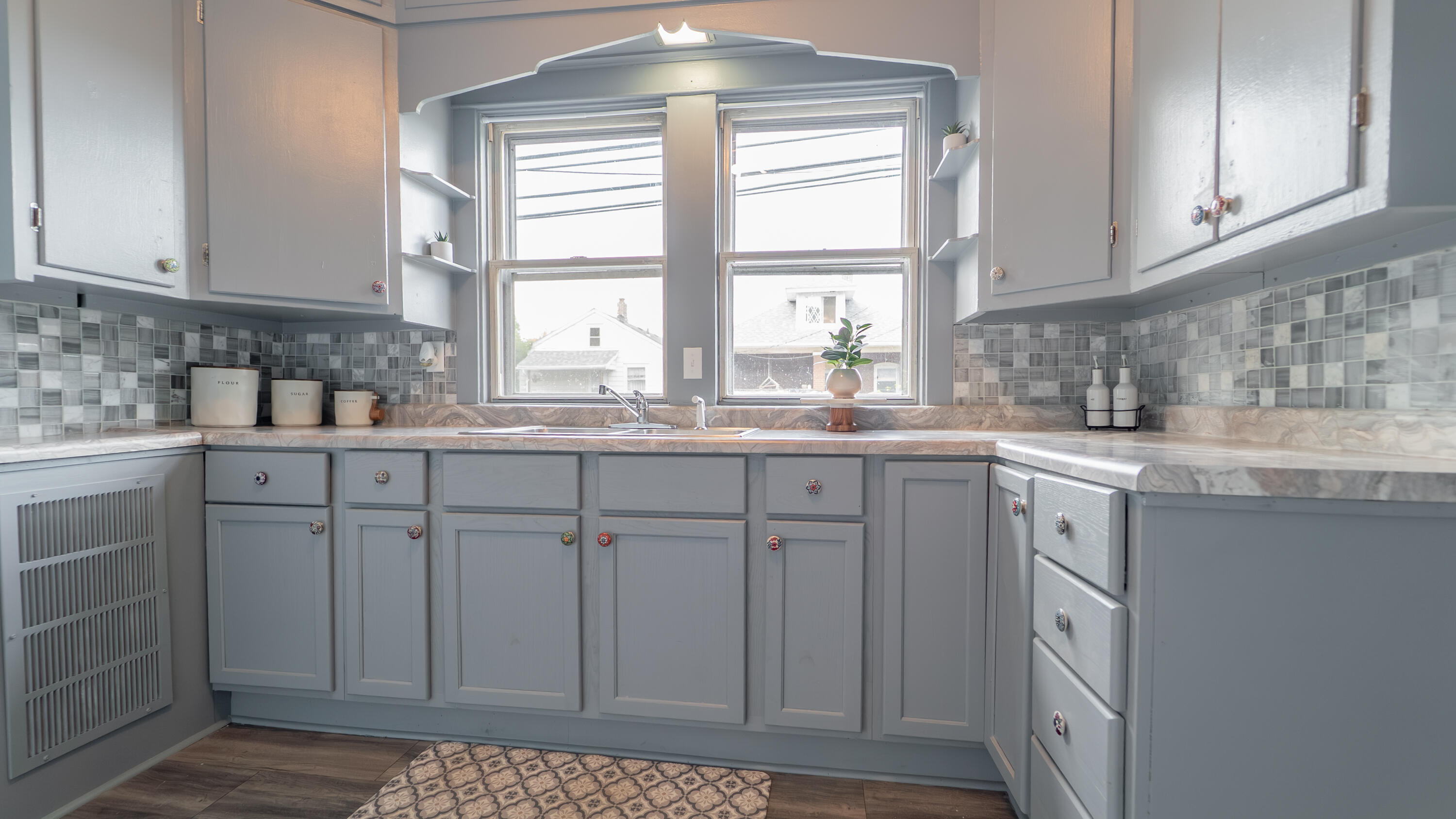 1916 Wespark Avenue Whiting, IN 46394 - Photo 13 of 32 a kitchen with stainless steel appliances granite countertop a sink and cabinets with wooden floor