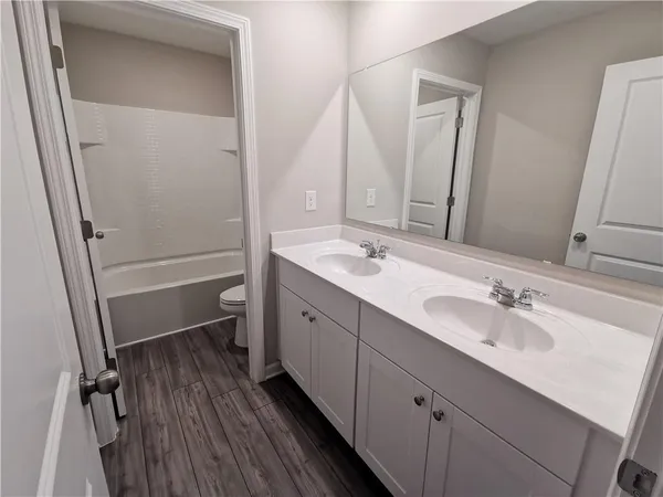 a bathroom with a sink a mirror and a shower