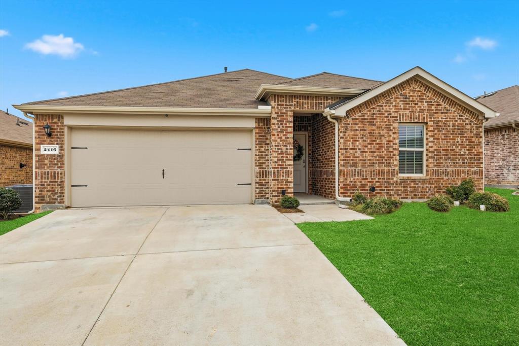 2416 Wildhaven Road Crandall, TX 75114 - Photo 2 of 35 a front view of a house with garden