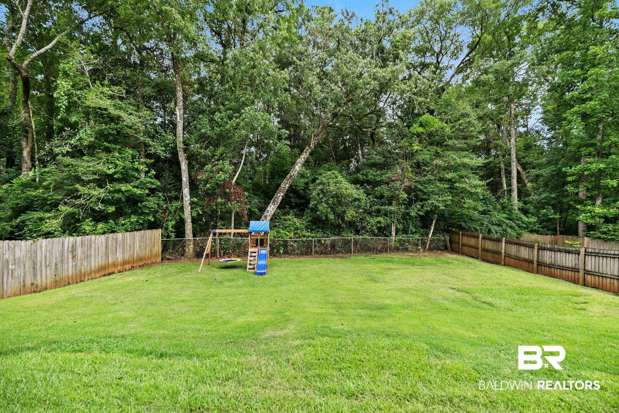 342 Ridgewood Drive Daphne, AL 36526 - Photo 27 of 36 View of yard featuring a playground