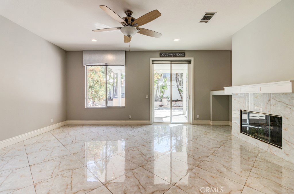 8 Zinnia Irvine, CA 92618 - Photo 18 of 39 a view of an empty room with a fireplace and a window