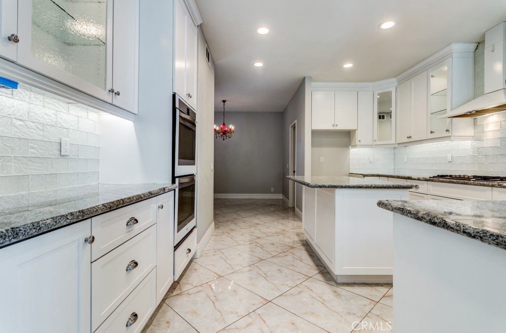8 Zinnia Irvine, CA 92618 - Photo 22 of 39 a kitchen with granite countertop cabinets and steel stainless steel appliances