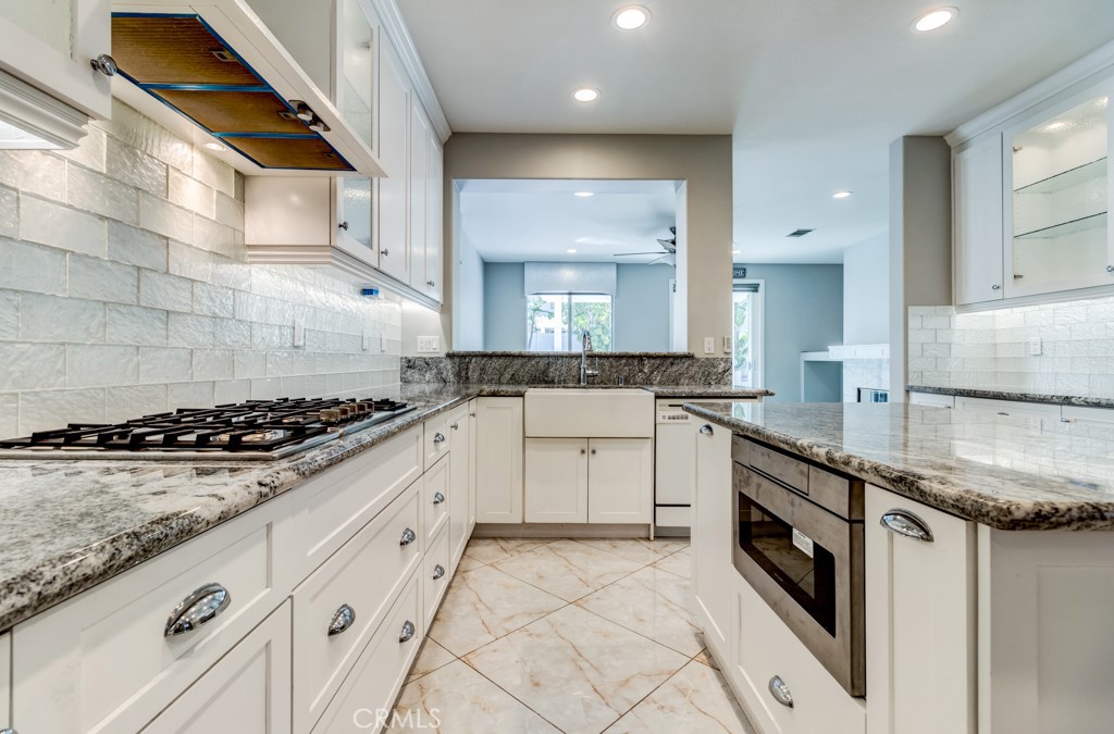 8 Zinnia Irvine, CA 92618 - Photo 24 of 39 a kitchen with stainless steel appliances granite countertop a sink and a stove