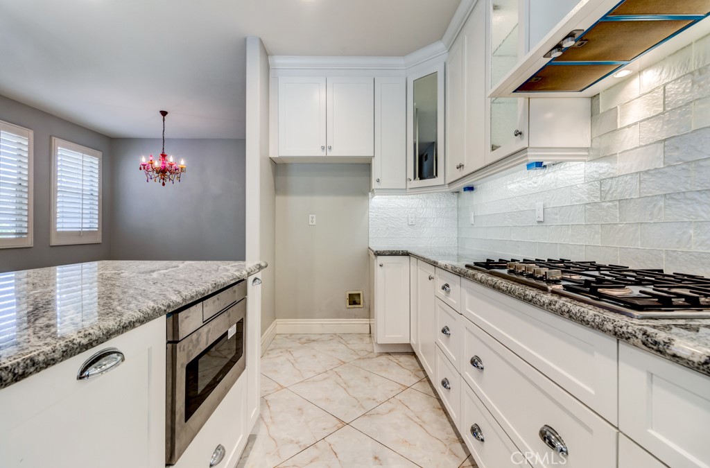 8 Zinnia Irvine, CA 92618 - Photo 26 of 39 a kitchen with granite countertop a stove and a sink