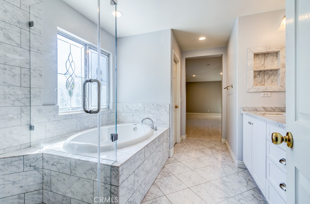 8 Zinnia Irvine, CA 92618 - Photo 32 of 39 a bathroom with a tub and a shower